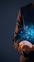 Businessman holding glowing digital network connections and data visualization in palm of hand representing future technology and innovation concepts.