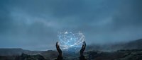 Two hands holding glowing digital sphere with network connections against stormy mountain landscape, representing technology, innovation, data, and future digital transformation concepts.