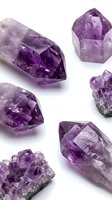 Raw amethyst crystals and gemstones collection isolated on white background for jewelry making, healing practices and mineral specimen display.