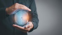 Male hands holding glowing blue and orange labyrinth symbol, representing problem solving, innovation, and strategic thinking for business solutions and technology concepts.