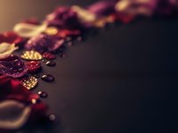 Luxury burgundy and gold abstract background with bokeh lights and elegant particles for premium design projects and festive celebrations.