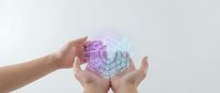 Hands protecting glowing digital cube with geometric wireframe structure representing data security, technology innovation and cyber protection concepts.