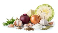 Fresh organic vegetables and herbs isolated on white background for healthy cooking and culinary preparations.