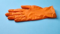 Orange latex glove isolated on blue background, ready for design use on apparel, promotional materials, and safety equipment graphics.