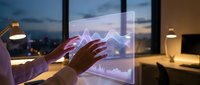 Business professional analyzing financial data on transparent touchscreen display with glowing charts and graphs in modern office environment at dusk.