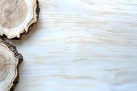 Natural wood slice cross sections on white wooden textured background, organic minimal composition with copy space for design layouts and presentations.