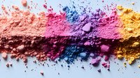Vibrant crushed makeup powder line in coral, pink, blue, purple and yellow shades on white background, macro cosmetic texture for beauty and fashion industry.