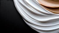 Elegant white and beige draped fabric creating smooth flowing curves and layers against dark background, abstract luxury textile design for fashion and interior decor.