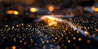 Abstract golden bokeh lights on dark background with glowing particles and light waves creating magical atmospheric effect for luxury design projects.