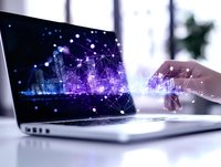 Modern laptop displaying futuristic cityscape with glowing network connections and digital transformation concept, purple and blue technology visualization.