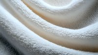 Soft white cream texture with smooth flowing waves and gentle curves creating luxurious cosmetic background for skincare and beauty product applications.
