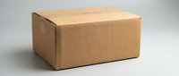 Closed cardboard shipping box with corrugated kraft paper on white background, isolated for packaging and logistics design use.