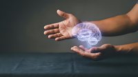 Human hands protecting glowing purple brain hologram representing mental health care, neuroscience research, artificial intelligence and cognitive protection concepts.
