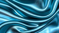 Luxurious turquoise silk fabric with elegant waves and folds creating smooth flowing curves and graceful ripples against dark background. Soft satin texture for fashion design.