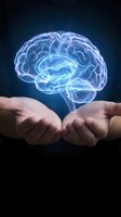 Glowing holographic brain floating above cupped hands representing artificial intelligence, neuroscience research, mental health awareness and cognitive science concepts.