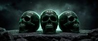 Three stone skulls with weathered texture sit on rocky ground under a starry night sky with atmospheric mist and fog, evoking themes of mortality, mystery, and the supernatural for horror and dark fantasy projects.