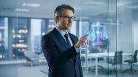 Middle-aged Caucasian businessman in suit using holographic legal scales interface in modern office, representing digital law and justice technology.