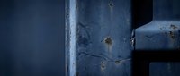 Close-up of weathered metal pipe with rust spots and patina, showing industrial decay and aged surface texture for construction and manufacturing projects.
