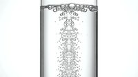 Carbonated water bubbles rising through clear liquid in glass, refreshing beverage concept for hydration and wellness design projects.