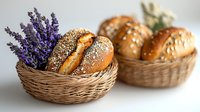Fresh baked bread rolls with sesame seeds in wicker baskets decorated with lavender sprigs, showcasing artisanal bakery products on light background.
