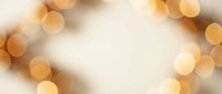 Soft golden bokeh lights creating warm ambient glow on cream background for holiday celebrations, wedding invitations, and festive design projects.