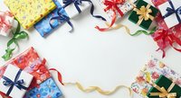 Colorful wrapped gift boxes with ribbons and bows arranged in circle on white background, overhead view with copy space for holiday, birthday, celebration, and festive design projects.