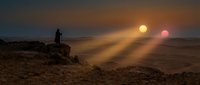 Lone figure silhouetted against dramatic sunset on rocky desert landscape with dual suns creating cinematic science fiction atmosphere for fantasy projects.