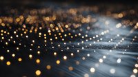 Abstract golden light particles flowing in waves with bokeh effect creating luminous trails against dark background for digital art projects.