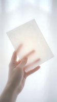 Hand holding transparent glass or acrylic sheet against soft white background for modern minimalist design and architectural presentation.