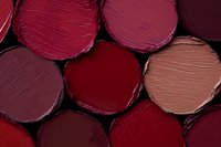 Colorful lipstick swatches in various red and pink shades showing different textures and finishes for makeup and beauty applications.
