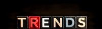 Glowing illuminated letters spelling TRENDS against dark background, modern typography design for business and marketing concepts and presentations.