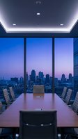 Modern conference room with expansive floor-to-ceiling windows overlooking illuminated city skyline at twilight. Long wooden table with ergonomic chairs, recessed ceiling lighting, and contemporary office design for corporate meetings.