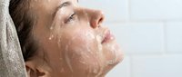 Woman with wet face and water droplets, skincare and beauty routine, spa and wellness treatment.