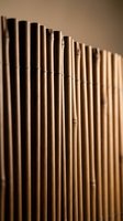 Natural bamboo tubes arranged in row creating organic texture pattern for spa wellness meditation and eco-friendly design projects.