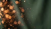 Abstract golden bokeh lights on dark green blurred background creating magical atmosphere for holiday celebrations and festive designs.