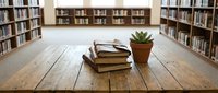 Stacked books and potted succulent plant on wooden table in library with bookshelves, suitable for education and reading content.