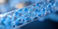 Molecular structure in glass tube with blue illumination shows hexagonal pattern of connected atoms, representing scientific research and nanotechnology advancement.