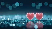 Two glowing pink hearts on reflective surface against dark blue bokeh background with soft light effects and romantic atmosphere for Valentine's Day designs.