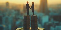 Silhouettes of business couple standing on equal coin stacks against urban sunset skyline, representing gender pay equality and financial partnership in workplace.