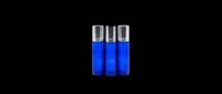Three cobalt blue glass roller bottles with silver caps, isolated on transparent background, ready for T-shirt design, stickers, clipart, and print on demand use.