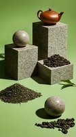 Modern tea composition with brown clay teapot, stone spheres, granite podiums and loose tea leaves on green background. Creative arrangement for tea packaging.