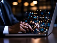 African American businessman typing on laptop with glowing digital network visualization, representing global connectivity and technology innovation.