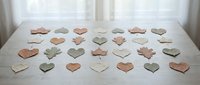 Wooden heart shapes arranged in rows on white surface creating romantic pattern for crafts, wedding decorations, Valentine's Day projects and DIY activities.