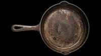 Vintage cast iron skillet with weathered patina and rust spots, isolated on transparent background. Ready for design use on t-shirts, clipart, stickers, print-on-demand products, and sublimation projects.