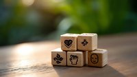 Wooden dice with wellness and healthcare symbols stacked on rustic table with soft bokeh background, representing holistic medicine and mindful living.