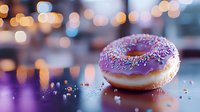 Purple glazed donut with colorful sprinkles on reflective surface against blurred bokeh lights background, creating dreamy atmosphere for food photography.