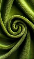 Mesmerizing spiral pattern in deep green textured fabric creates hypnotic swirl effect against dark background, suitable for abstract design and textile concepts.