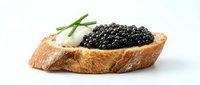 Toasted bread slice topped with creamy spread, luxurious black caviar, and fresh green garnish. Gourmet appetizer for fine dining, catering, food photography, and culinary publications.