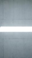 Minimalist concrete wall with horizontal white light stripe across center, featuring industrial texture and panel divisions for modern architecture and design projects.