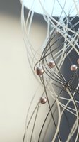 Intertwined white and dark threads with copper spheres suspended throughout, creating an abstract network composition suitable for modern design projects.